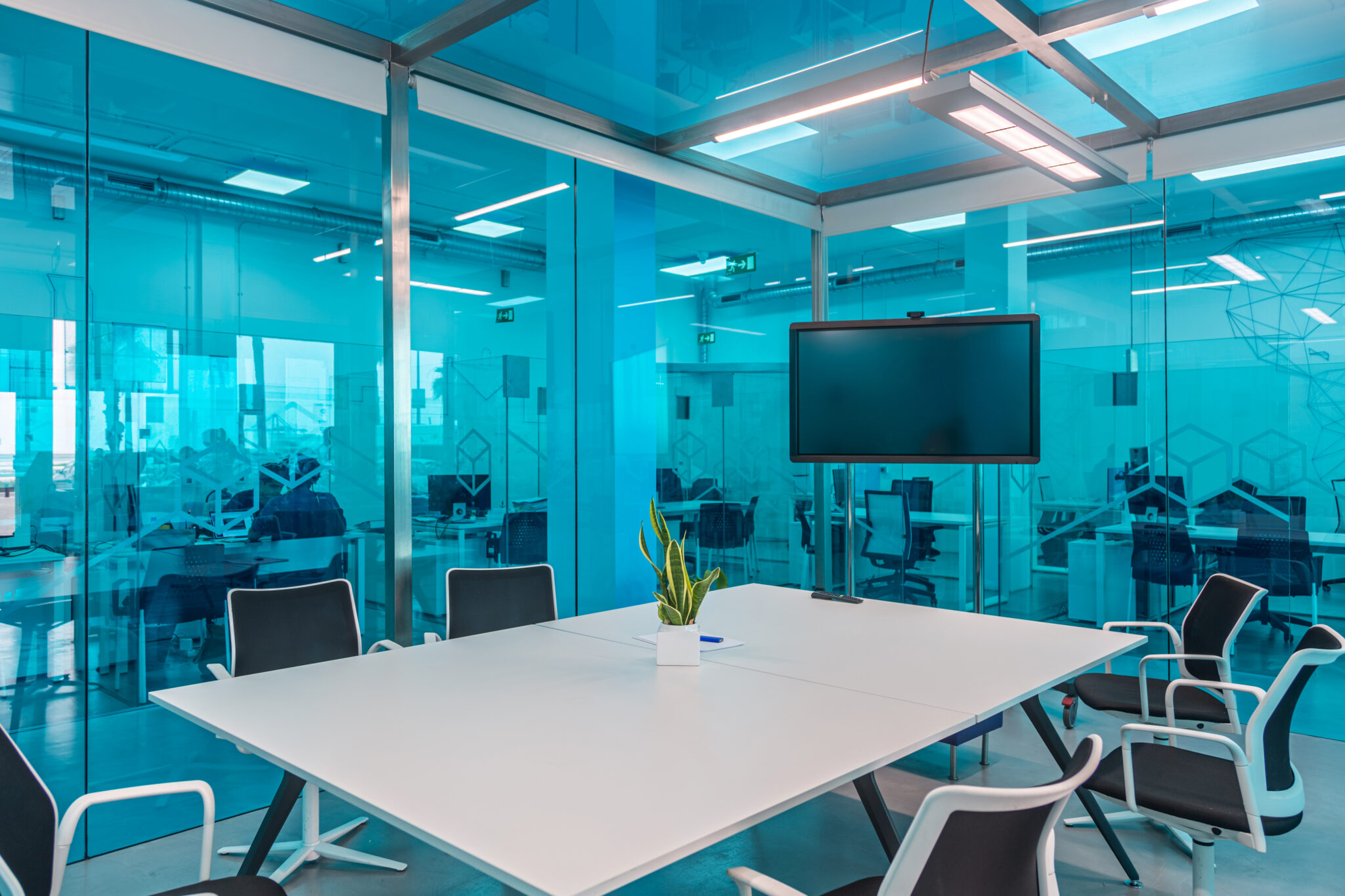 Modern office meeting room with glass walls.